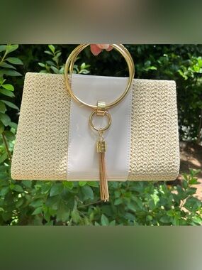NEW. Cream Woven Clutch with Gold Ring Handle and Tassel